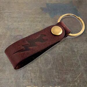 Leather key fob with a brass snap and ring; 'BLACK' text shown at the bottom